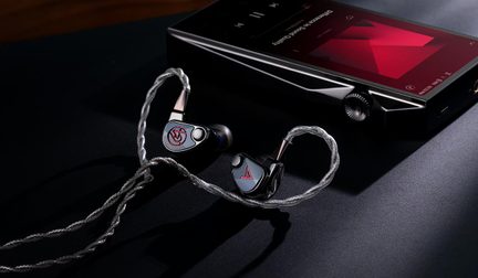Dark gray and silver metal in-ear earphones with light gray faceplates featuring red logos, silver braided cable, top view