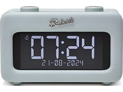 Radio modiņš Roberts Revival Rest, taisnstūradaļīgs apvalks ar debesszila zīmētu mākslīgo ādu, lielu melnu ciparu balto skaitļu digitālo ekrānu, divām cilindriskām vadības pogām uz augšpuses, skats no priekšas