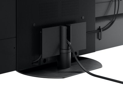 Téléviseur haute définition Panasonic TV-65Z95AEG, vue arrière, câbles connectés, support central noir, surface texturée