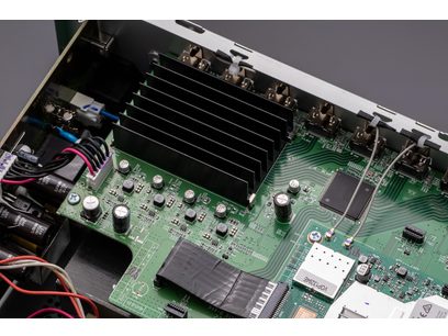 Carte électronique verte avec composants électroniques, radiateurs en aluminium et connecteurs, vue rapprochée de dessus