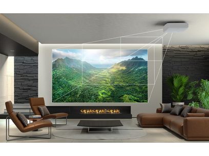 Salon moderne avec canapés bruns, cheminée encastrée, projection murale d'un paysage montagneux verdoyant