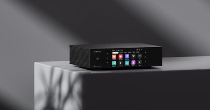 Black metal multimedia enclosure, rectangular with fins, front color display with icons and power button, 3/4 front view