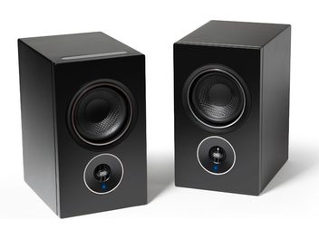 Enceintes compactes PSB Alpha iQ noir mat, 2 haut-parleurs, façade noire, bouton bleu, forme cubique, vue de face et 3/4 arrière