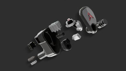 Metallic gray and black in-ear earphone made of metal and plastic, exploded three-quarter perspective view showing glossy shell, black cavity, circular driver, circuitry, two-pin connector, and anthracite faceplate with red triangular logo